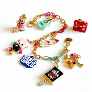 Colorful enamel charm bracelet with gold links and assorted novelty rebel girl pendants