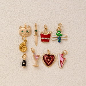 Set of 8 colorful gold-plated charms including cat, shell and heart for DIY jewelry making