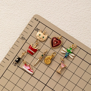 Set of 9 gold-plated enamel charms featuring animals and objects for DIY jewelry making