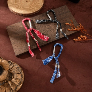 Three bohemian paisley print keychain charms in red, blue, and black with metal beads