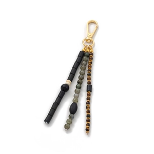 Detail of bohemian keychain with mixed marble beads, tiger eye stones, and gold metal clasp