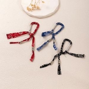 Three-piece paisley pattern cloth keychain set in red, blue, and black with metal carabiners