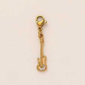 Close-up of golden electric guitar pendant with silver accents and lobster clasp