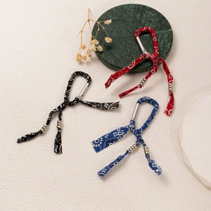 Ethnic style keychains with red, black, and blue paisley fabric and silver carabiners