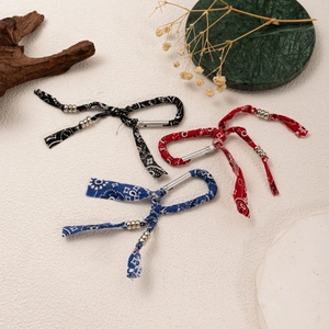 Detail of bohemian bandana keychain charms with metal beads and spring snap hooks