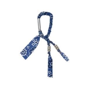 Detail of blue paisley fabric keychain with silver metal beads and spring hook