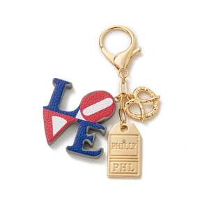 Close-up of Philly theme keychain with red LOVE charm and golden pretzel detail