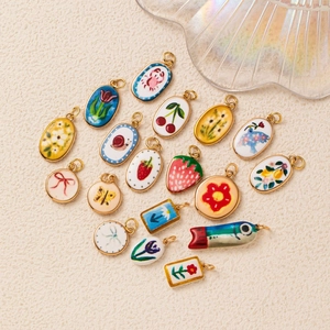 Assorted gold-plated ceramic charms with floral and animal motifs for DIY jewelry making