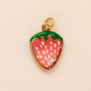 Detailed view of pink strawberry charm with enamel finish and gold-plated ring connector