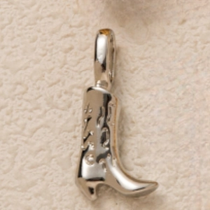 Detail of silver cowboy boot pendant with hollow pattern and large hanging loop