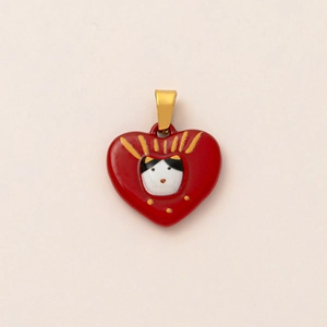 Detail of red heart pendant with cat motif and 18K gold plated finish
