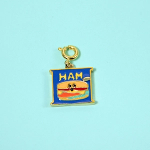 Detailed macro view of a square blue enamel burger charm with a gold-plated spring clasp