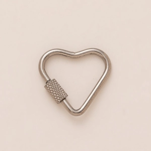 Detailed macro view of heart-shaped stainless steel carabiner with knurled screw lock