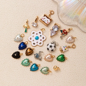 Assorted colorful enamel heart and mushroom charms in gold-plated copper for DIY jewelry