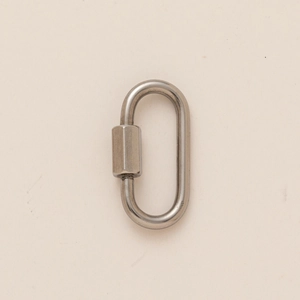 Macro detail of oval stainless steel quick link connector with a hexagonal screw locking nut