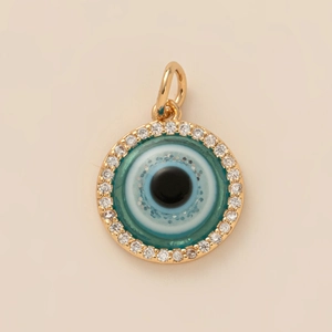 Close-up of a gold-plated circular Evil Eye pendant with white pavé cubic zirconia