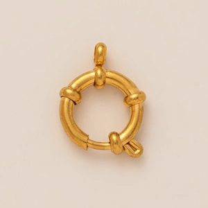 Macro detail of a 18k gold-plated round spring clasp for jewelry making and DIY projects