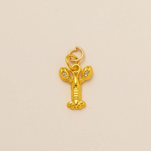 Detailed close-up of a gold lobster pendant with sparkling zircon-inlaid claws