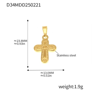 Macro view of gold stainless steel cross pendant showing precise dimensions and textured dots