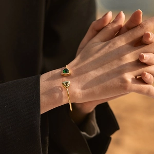 Minimalist 18K gold plated brass bangle with triangular emerald green stone and small crystals