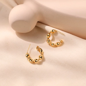 Polished gold geometric twisted C-shape earrings with minimalist spiral wave design