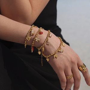 Gold beaded bracelets and ring set featuring zircon clover, bee, and heart charms for women