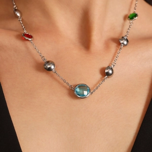 Polished silver chain necklace featuring multi-color round cut gemstones and metal beads