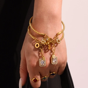 Gold-plated stainless steel jewelry set with colorful gemstone rings and letter bracelet