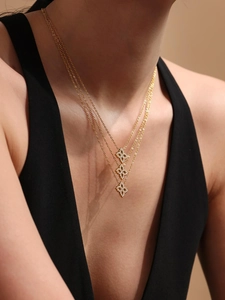 Nahaufnahme einer eleganten Goldkette mit Zirkonia-Anhängern im Blumendesign