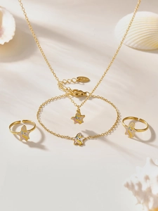 Detailed view of colorful unicorn star charms on gold necklaces and bracelets