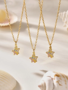 Detailed view of unicorn star pendants on gold chains with colorful enamel finish