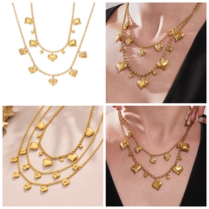 Detailed view of layered 18k gold plated heart necklaces with micro-inlaid M letter zircon