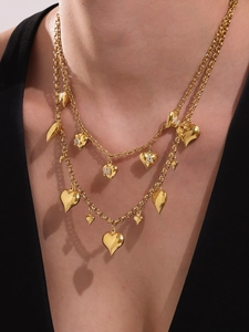 Detail of 18k gold plated double-layer necklace with heart charms and zircon M A letters