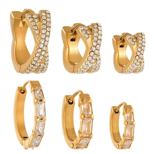 Golden huggie hoop earrings set with micro-paved cubic zirconia and baguette-cut stones