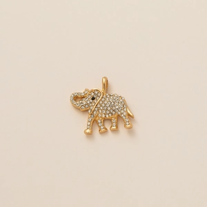 Detailed view of a gold elephant pendant featuring pavé-set stones and a black gemstone eye