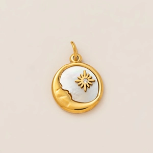 Detail of a 18K gold circular pendant with white mother of pearl and moon face relief