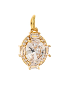 Macro shot of gold oval birthstone pendant with cubic zirconia and shiny metal finish