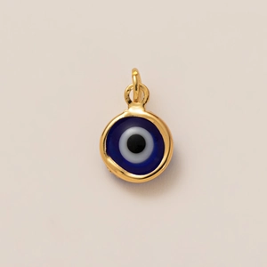Macro view of 18K gold plated evil eye pendant with deep blue enamel and gold bail