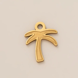 Macro detail of a 18K gold-plated stainless steel palm tree pendant for DIY jewelry