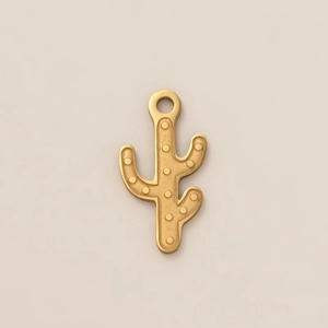 Macro detail of a 18K gold-plated cactus pendant with embossed texture for DIY jewelry