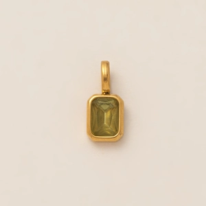 Detail of emerald-cut yellow-green gemstone pendant with gold-plated metal frame