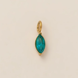 Detailed close-up of a marquise-cut blue gemstone pendant with a polished gold frame