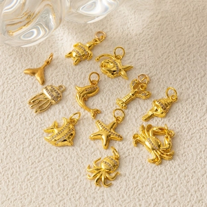 Gold marine life pendants featuring sea turtles and dolphins with micro-set zircons