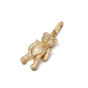 Detail showing a brushed golden bear pendant with pearl eyes on white background