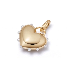 Detailed macro view of a gold heart pendant with pearl accents and cable bail