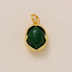 Detailed close-up of a vintage oval dark green gemstone pendant with 18K gold plated frame