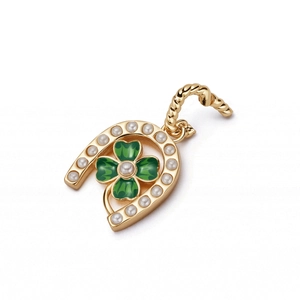 Macro shot of gold horseshoe pendant with green clover enamel and pearl details