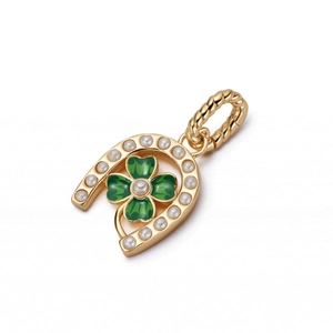 Detail of horseshoe pendant with green clover enamel and pearl inlay on a twisted ring