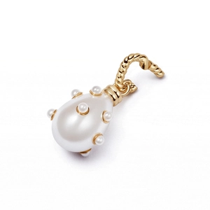 Detailed macro of a pear-shaped white faux pearl pendant with gold twisted rope ring charm