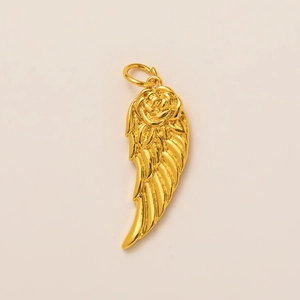 Macro view of 18K gold-plated rose and angel wing pendant with 3D embossed metal details
